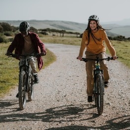 Man and woman riding bikes in the countryside