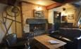 Large seats around open fire at The Griffin, Godshill, pub