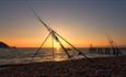 Sunset and fishing rods at Alum Bay beach, Isle of Wight, Things to Do