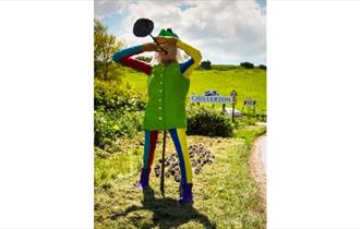 Isle of Wight, Scarecrow Festival, Image of standing full size Scarecrow by Chillerton sign.