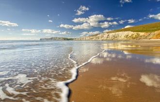 Sunny day with few clouds in the sky over Compton Beach, Isle of Wight, Things to Do