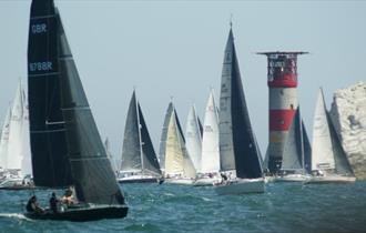 Yachts sailing around the Needles competing in the Round the Island race, Alum Bay, Isle of Wight, What's on.
