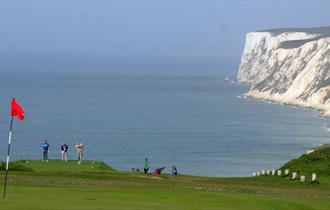 Group of people playing at Freshwater Golf Club with the English Channel in the background, Isle of Wight, activities