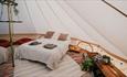Bed inside bell tent, Island Bell Tents, glamping, self catering, Isle of Wight