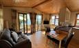 Lounge and kitchen in cabin at Old Mill Holiday Park, Isle of Wight, Self Catering
