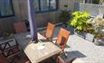 Outdoor dining table and chairs within enclosed courtyard garden at The Old School Hall, Shanklin, Self catering, Isle of Wight
