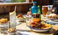 Burger, chips and drinks on a table at The Cow Restaurant, Food & Drink, Tapnell Farm Park, Isle of Wight