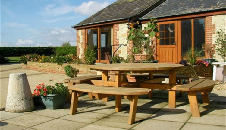 Outside view of Rose Cottage with outdoor picnic table, Atherfield Green Farm Holiday Cottages, Chale, Self Catering