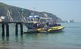 Boat and RIB at the pier on Alum Bay beach, Needles Pleasure Cruises, Isle of Wight, Things to do
