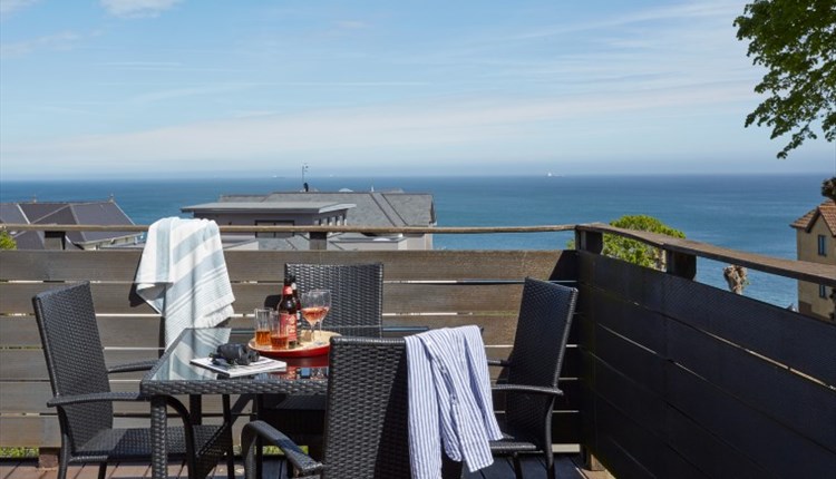 Outside dining table and chairs on balcony with sea views at Shanklin Villa Aparthotel, Isle of Wight, Self catering