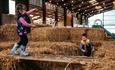 Kids playing on the straw bale at Tapnell Farm Park, Things to Do, Isle of Wight