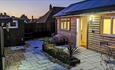Outside view of Totland Bay Cabin at night-time, self-catering, Isle of Wight
