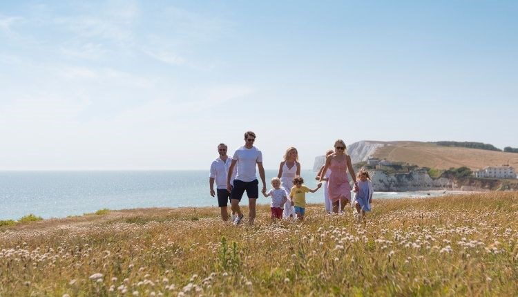 Group of people walking along the cliff at Freshwater Bay, Isle of Wight - copyright: visitisleofwight.co.uk