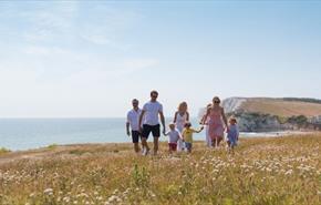 Group of people walking along the cliff at Freshwater Bay, Isle of Wight - copyright: visitisleofwight.co.uk