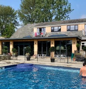 Apartments and The Core Complex overlooking the outdoor swimming pool at Appuldurcombe Gardens Holiday Park, Self catering, Isle of Wight