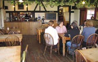 People enjoying food inside The Blacksmiths, Isle of Wight, local produce, let's buy local