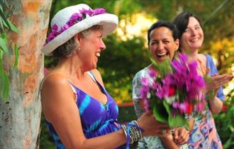 Group of woman laughing, creativity workshop at The Grange, Shanklin, Isle of Wight, wellness event