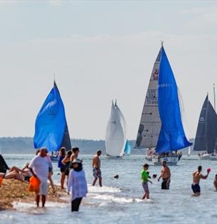 People swimming in the sea watching the boats sailing, Cowes Week, event, what's on