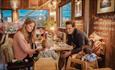 Family eating inside The Cow Restaurant, Food & Drink, Tapnell Farm Park, Isle of Wight