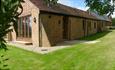 Outside view of Lacewood barn surrounded by garden, Fernhill Barns, Wootton, Isle of Wight, self-catering