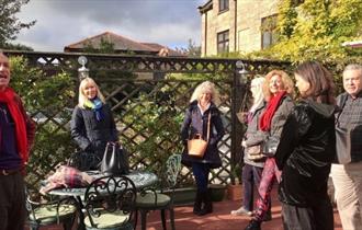 Group of people laughing outside, creating laughter workshop at The Grange, Shanklin, Isle of Wight, wellness event