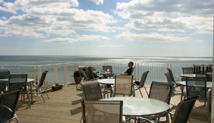 Outside deck with dining table and chairs at The Wellington Hotel, Ventnor