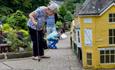 Lady and child viewing the miniature buildings at the Godshill Model Village, Isle of Wight, Things to Do