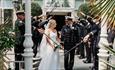 Bride and groom walking through a guard of honour outside The Royal Hotel, Ventnor, Isle of Wight, weddings