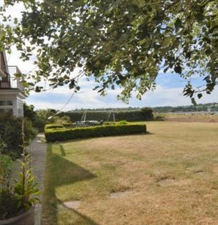 Side view of house with garden leading to the watersedge  - self-catering, Isle of Wight, HB Holiday Lettings