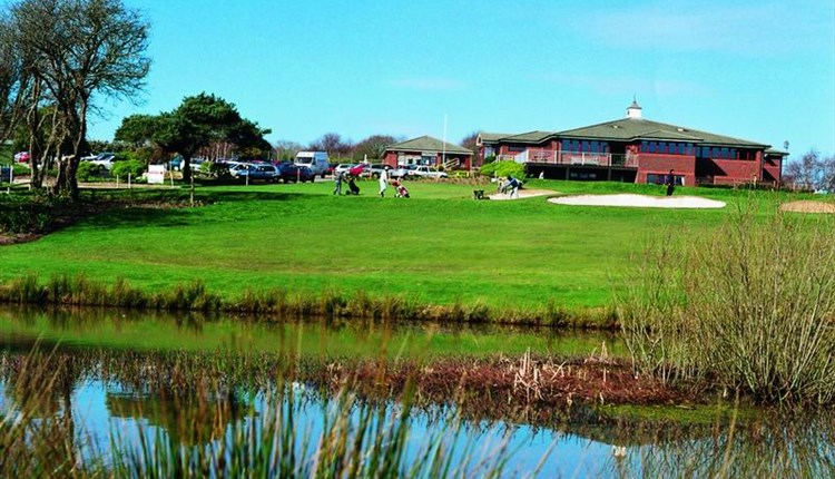 Shanklin & Sandown Golf Club's course and lake with the clubhouse in the background, Isle of Wight, activity