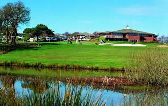 Shanklin & Sandown Golf Club's course and lake with the clubhouse in the background, Isle of Wight, activity