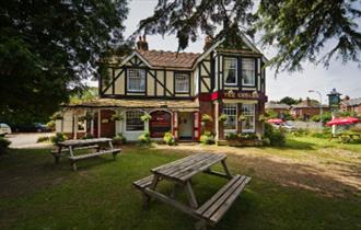 Outside view of The Cedars with seating area, Wootton, pub