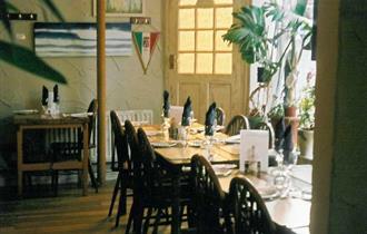 Tables and chairs inside of Toninos Italian Restaurant, Cowes, eat and drink