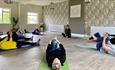 Group enjoying yoga class in the studio at Appuldurcombe Gardens Holiday Park, Isle of Wight, Self catering