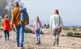 Family walking on the beach at the Isle of Wight Walking Festival, what's on