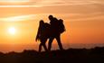 Couple walking on cliff at sunset, Isle of Wight, what's on