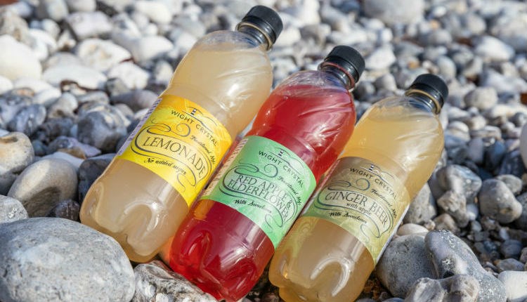 Selection of soft drinks produced by Wight Crystal laid on the beach, Isle of Wight, local produce, let's buy local