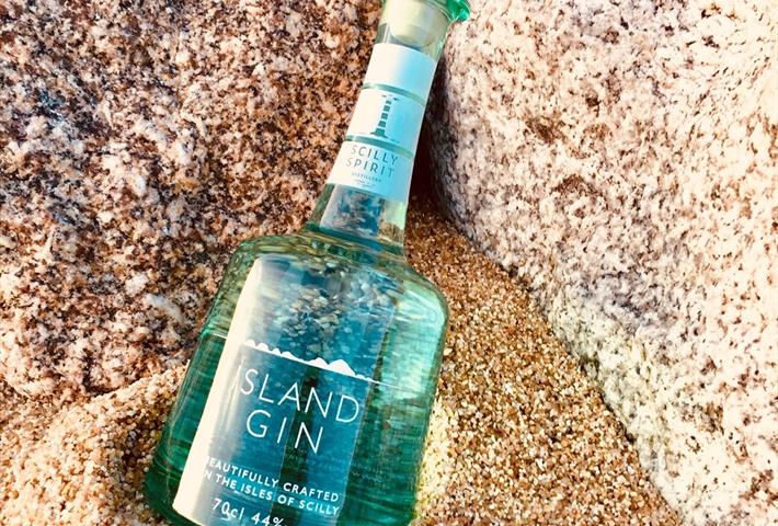 Bottle of island gin in the sand