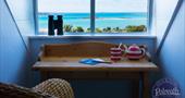 Sea views from the writing desk in Polreath double room en suite on the 2nd floor. There is a pair of binoculars on the windowsill and a red and white