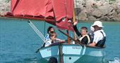 Young family out in rat sail boat