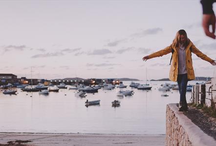 Lady walking overlooking harbour