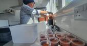 Chilli powder being put into tubs
