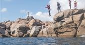 Kernow Coasteering jumping off rock