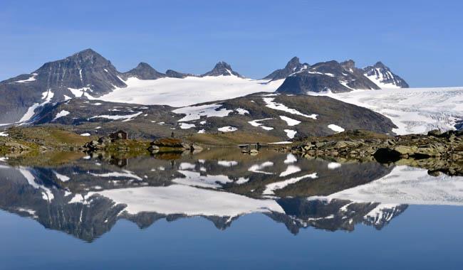 Smørstabbtindane seen with clear water in front at Sognefjellet.