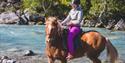 On a horseback by the river Skjøle.