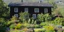 Aukrust farm, a house and flowers and herbs in front.