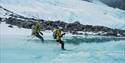 Two guides skiing on water.