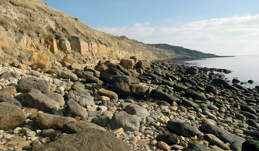 Rocky beach picture, sandy beach picture and map showing meeting point for the walk