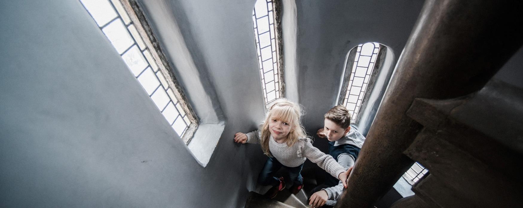 Children exploring Lyme Regis Museum's staircase