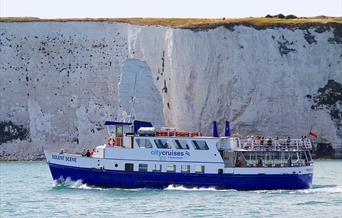 City Cruises' boat against the backdrop of white Chalk cliffs on the Jurassic Coast near Swanage